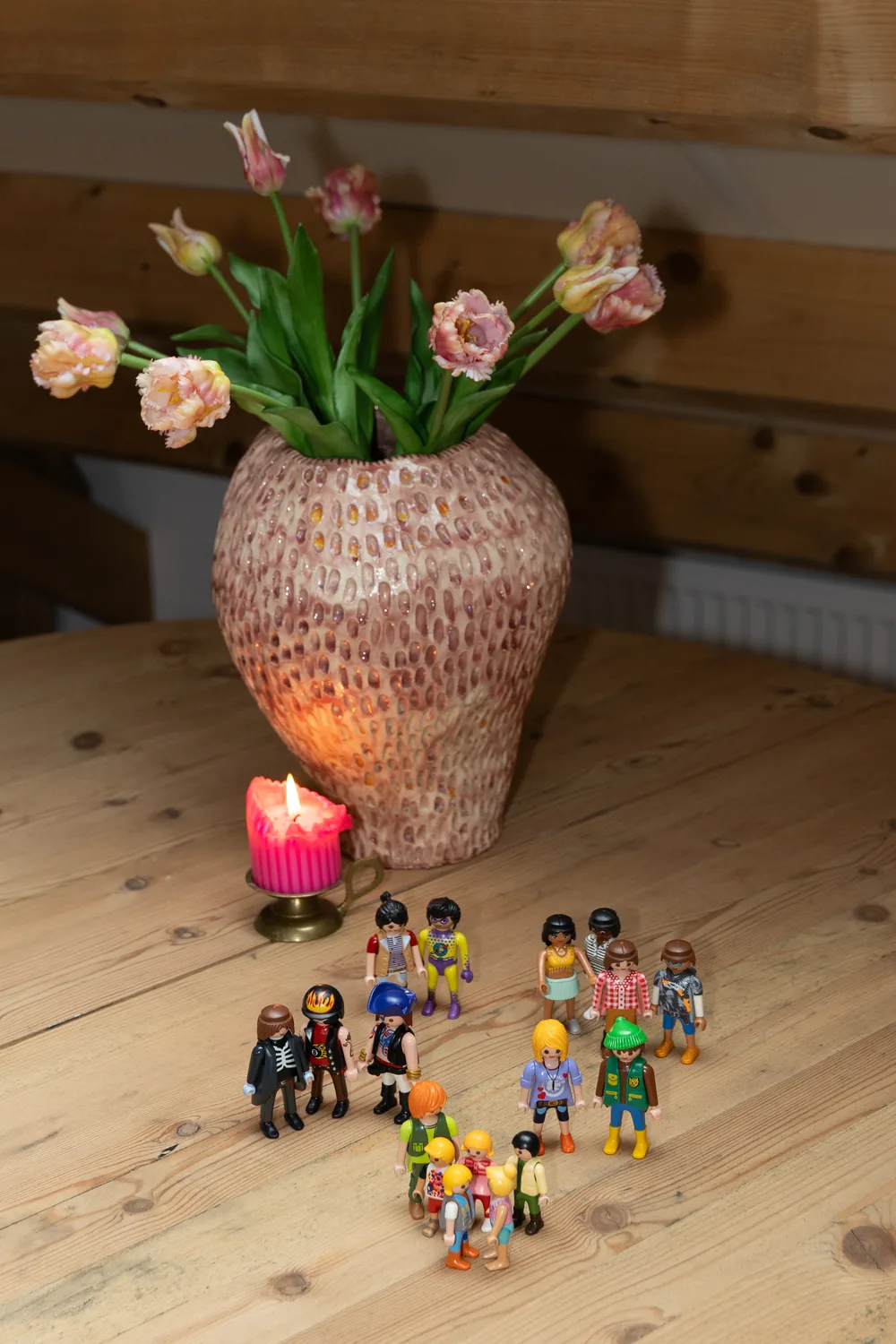 Speelgoedfiguren in groepjes op de ronde tafel, gebruikt bij team- en organisatieopstellingen